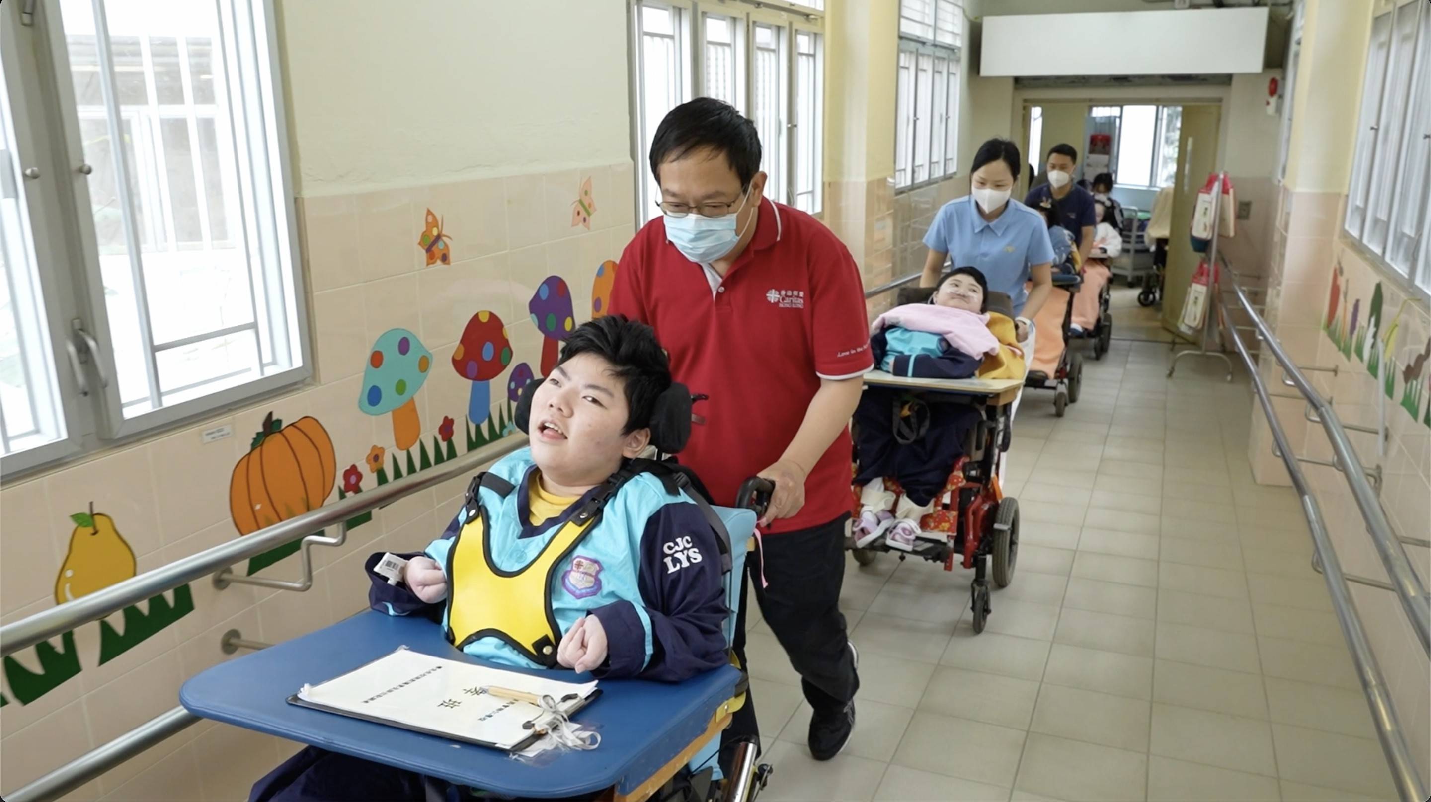 Teachers taking the students to school from the hospital.
